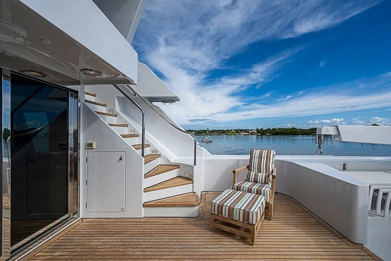 Slide: The Image of Luxurious 1997 Delta Marine Tri-deck Motoryacht deck with striped lounge chair and scenic water view. - 71