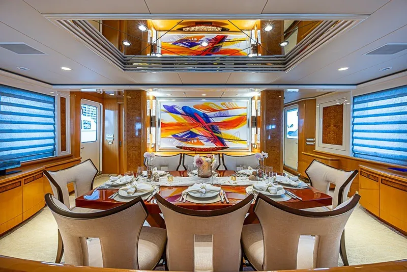 Slide: The Image of Luxurious dining area on a 1997 Delta Marine Tri-deck Motoryacht with vibrant artwork. - 10