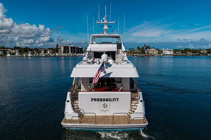 Slide: The Image of Delta Marine Tri-deck Motoryacht, 1997, cruising on a serene waterway under a clear blue sky. - 95