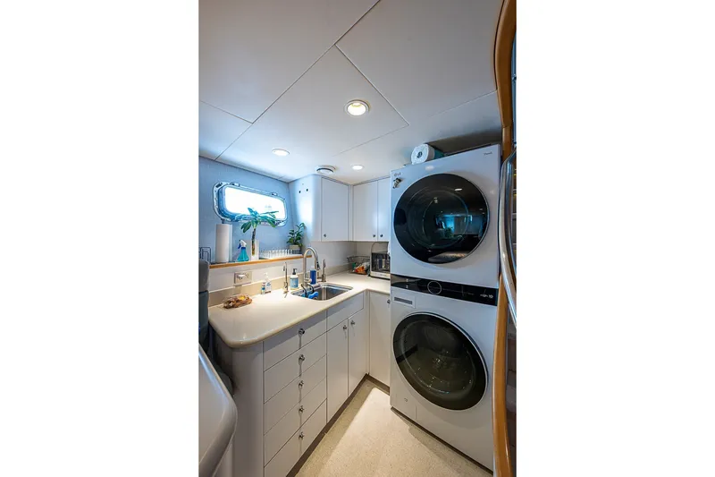 Slide: The Image of Laundry room in 1997 Delta Marine Tri-deck Motoryacht with washer, dryer, and sink. - 60
