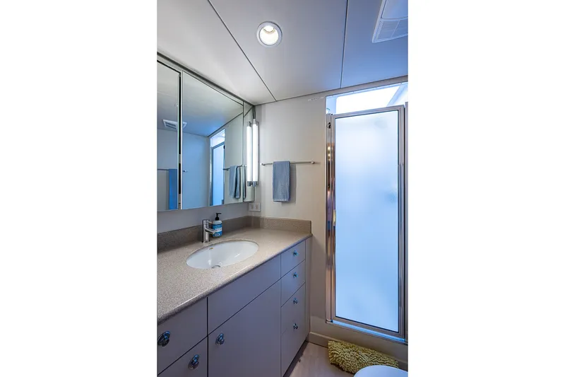 Slide: The Image of Luxurious bathroom on 1997 Delta Marine Tri-deck Motoryacht with modern fixtures and frosted glass shower. - 56