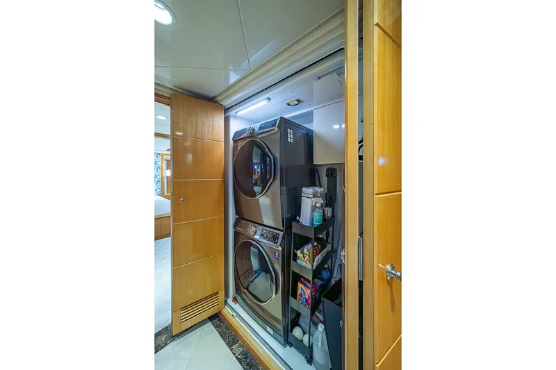 Slide: The Image of Laundry area on 1997 Delta Marine Tri-deck Motoryacht with stacked washer and dryer. - 32