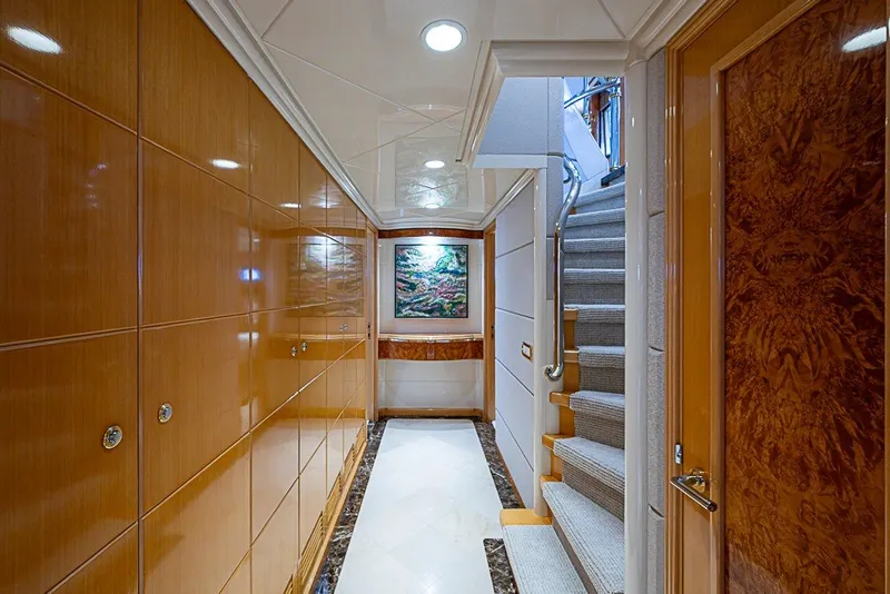 Slide: The Image of Luxurious hallway in a 1997 Delta Marine Tri-deck Motoryacht with elegant wood paneling and staircase. - 31