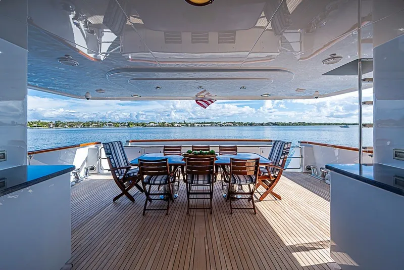 Slide: The Image of Luxurious 1997 Delta Marine Tri-deck Motoryacht with elegant outdoor dining area and scenic ocean view. - 61