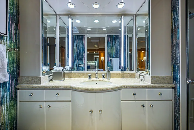 Slide: The Image of Luxurious bathroom vanity on 1997 Delta Marine Tri-deck Motoryacht, featuring elegant lighting and mirrors. - 43