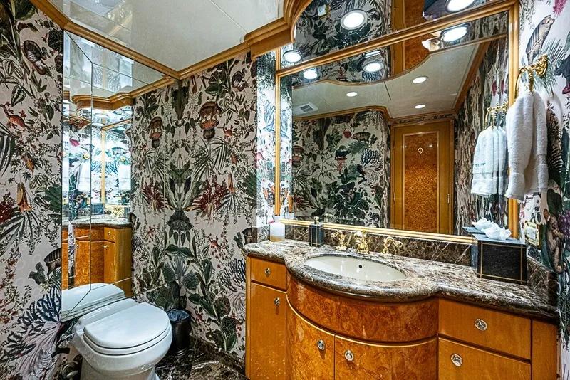 Slide: The Image of Luxurious bathroom on 1997 Delta Marine Tri-deck Motoryacht with ornate wallpaper and marble accents. - 14