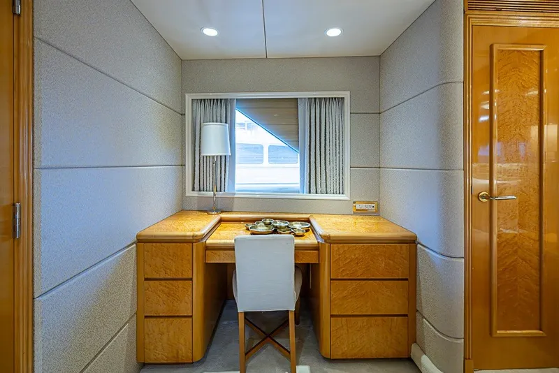 Slide: The Image of Luxurious wooden desk area on 1997 Delta Marine Tri-deck Motoryacht, featuring elegant design and lighting. - 42