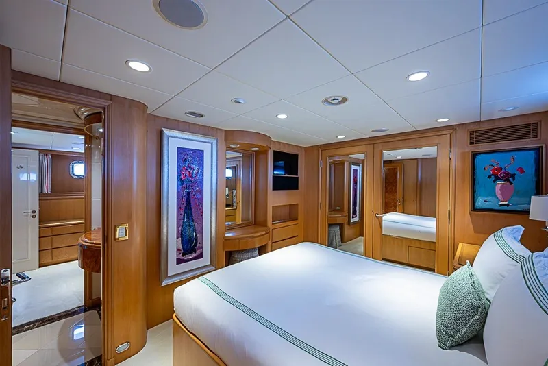 Slide: The Image of Luxurious bedroom interior on 1997 Delta Marine Tri-deck Motoryacht, featuring elegant wood paneling. - 49