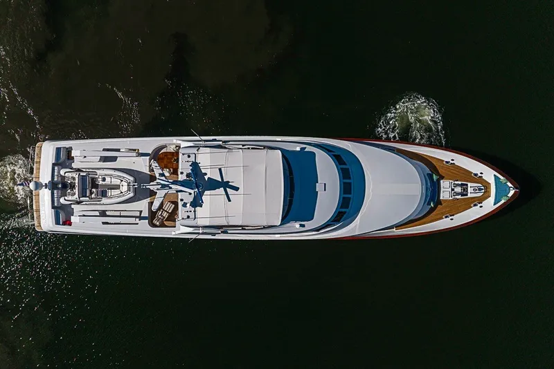 Slide: The Image of Aerial view of 1997 Delta Marine Tri-deck Motoryacht cruising on dark water. - 91