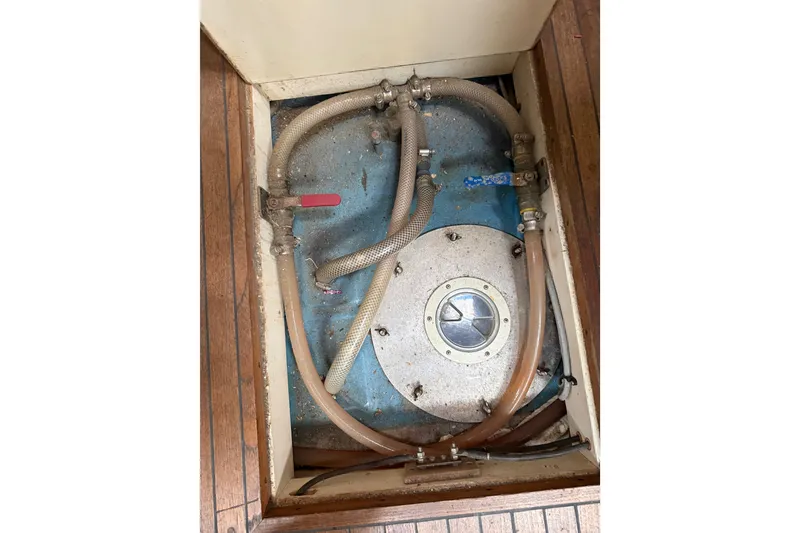 Slide: The Image of Boat engine compartment with hoses and access panel, Custom 46, 1990 model. - 12