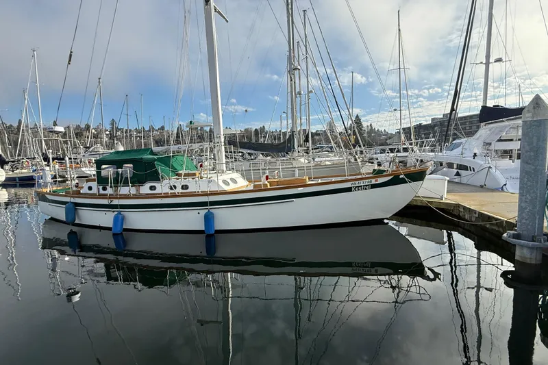 Slide: The Image of Sailboat docked at marina, HMMD 46 model, 1990, with clear reflections on water. - 2