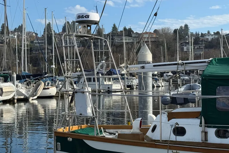 Slide: The Image of Sailboats docked at a marina with a 1990 HMMD 46 model in the foreground. - 3