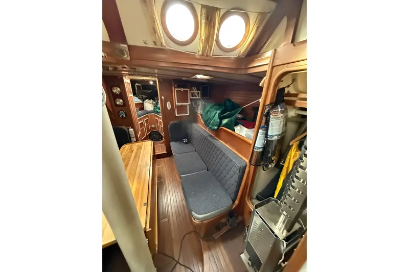 Slide: The Image of Cozy 1990 Custom 46 yacht interior with wooden furnishings and seating area. - 20