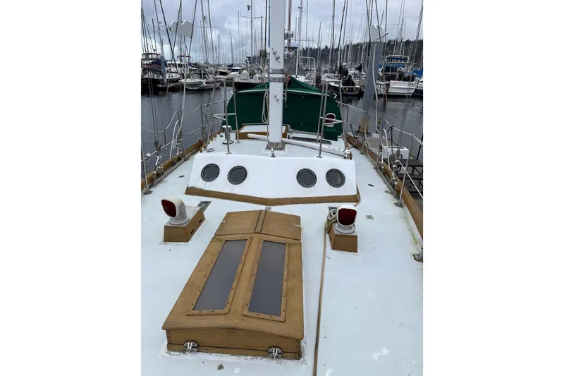 Slide: The Image of Sailboat deck view in marina, HMMD 46 model, 1990, with wooden accents and portholes. - 6