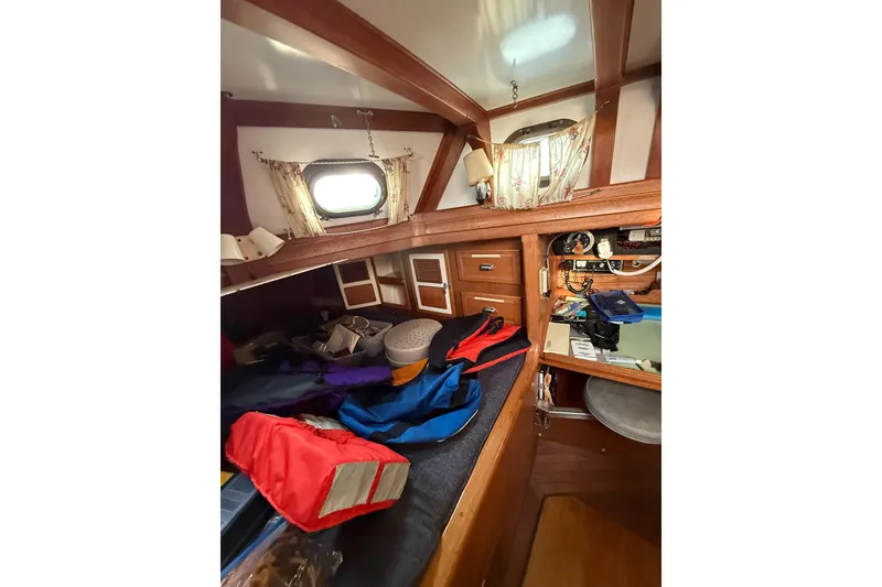 Slide: The Image of Cozy cabin interior of 1990 Custom 46 sailboat with nautical decor and storage. - 16