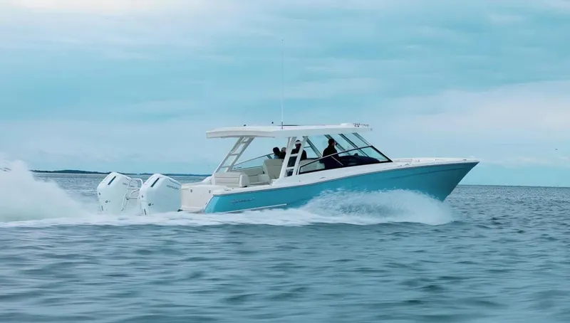 The Image of 2026 World Cat 400DC-X Island cruising on open water, showcasing sleek design and powerful engines. - 0