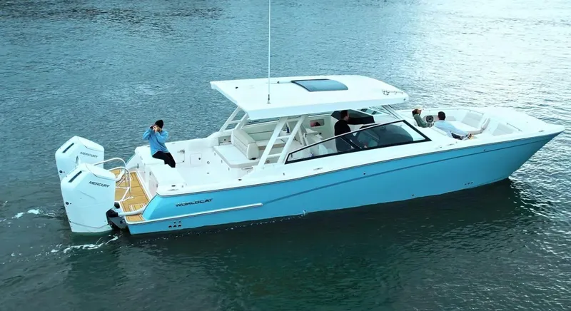 Slide: The Image of 2026 World Cat 400DC-X Island boat cruising on water, featuring dual outboard engines. - 1