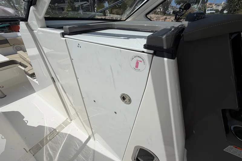 Slide: The Image of 2019 Pursuit DC 365 Dual Console interior with fire extinguisher compartment. - 60