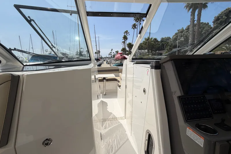 Slide: The Image of 2019 Pursuit DC 365 Dual Console boat interior with marina view. - 59