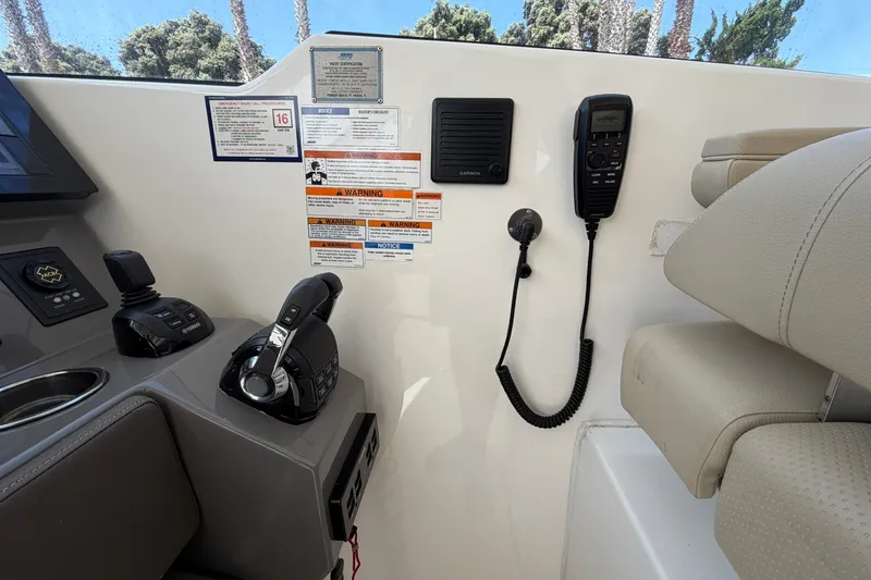 Slide: The Image of Control panel of a 2019 Pursuit DC 365 Dual Console boat with navigation equipment. - 34