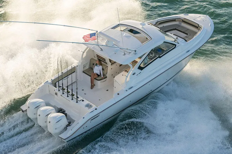 Slide: The Image of Manufacturer Provided Image: 2019 Pursuit DC 365 Dual Console boat cruising on water with American flag. - 81