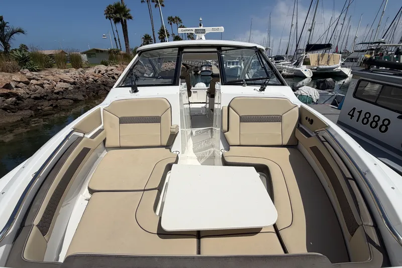 Slide: The Image of 2019 Pursuit DC 365 Dual Console boat with spacious seating, docked in a marina. - 68