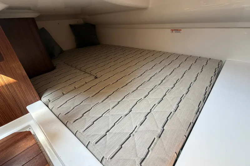 Slide: The Image of 2019 Pursuit DC 365 Dual Console cabin interior with cushioned sleeping area. - 58