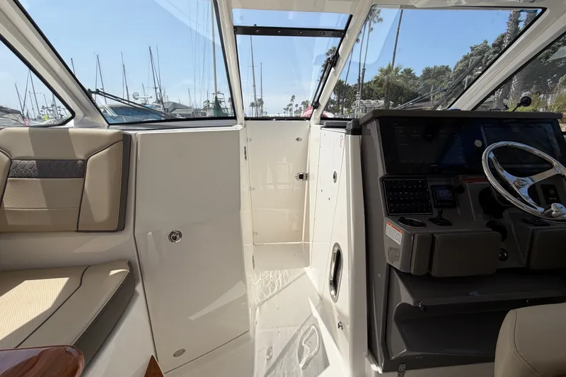 Slide: The Image of 2019 Pursuit DC 365 Dual Console interior with helm and seating area. - 46