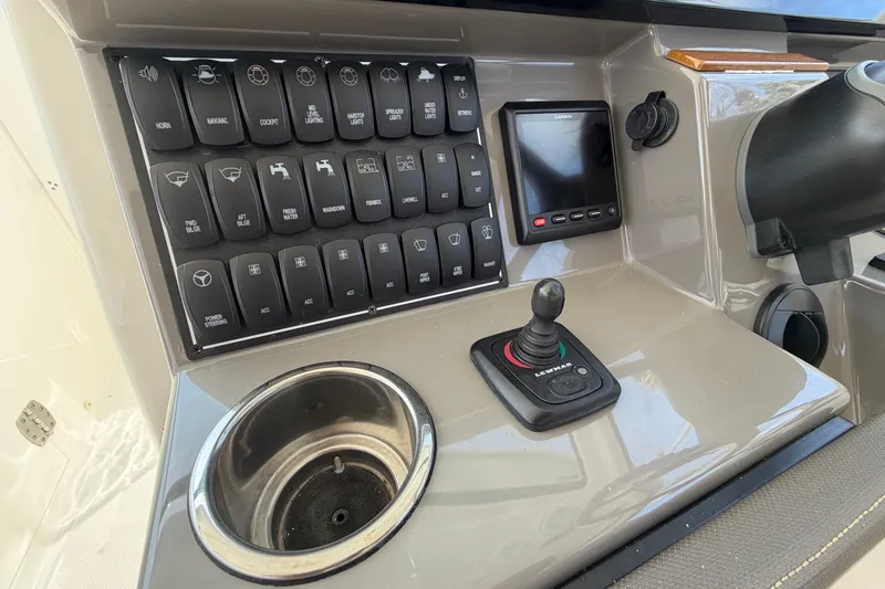 Slide: The Image of Control panel of a 2019 Pursuit DC 365 Dual Console boat with joystick and switches. - 29
