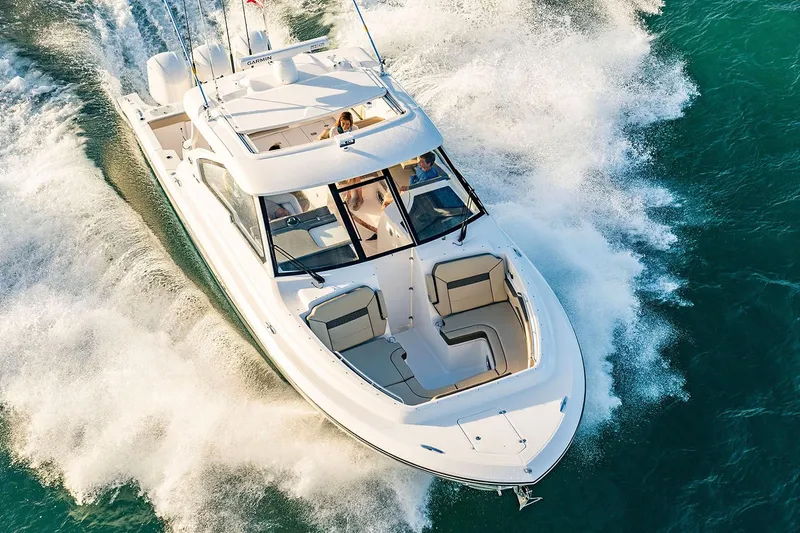 Slide: The Image of Manufacturer Provided Image: 2019 Pursuit DC 365 Dual Console boat cruising on water. - 79