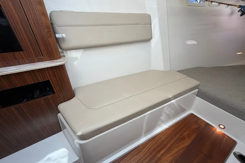 Slide: The Image of 2019 Pursuit DC 365 Dual Console interior with beige seating and wooden accents. - 51