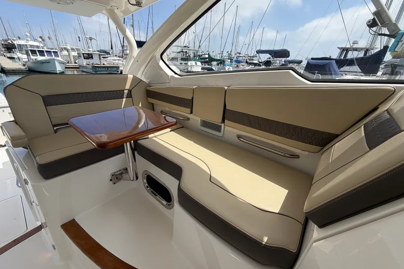 Slide: The Image of Luxurious seating area on a 2019 Pursuit DC 365 Dual Console boat in a marina. - 41
