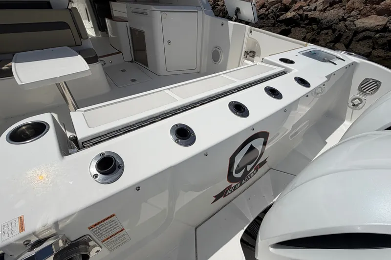 Slide: The Image of 2019 Pursuit DC 365 Dual Console boat interior with seating and storage compartments. - 17