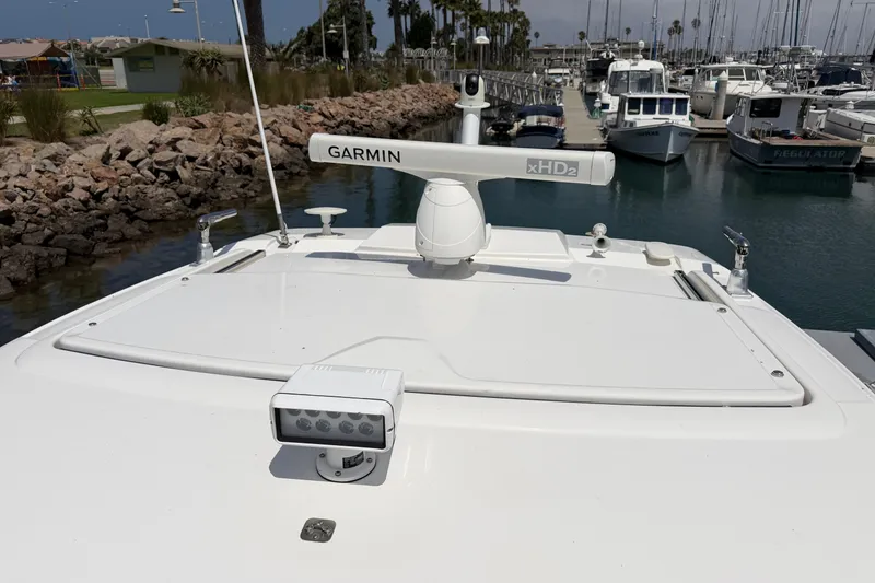 Slide: The Image of 2019 Pursuit DC 365 Dual Console boat with Garmin radar in a marina setting. - 73