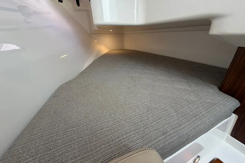 Slide: The Image of Interior cabin of 2019 Pursuit DC 365 Dual Console boat with cushioned seating. - 56