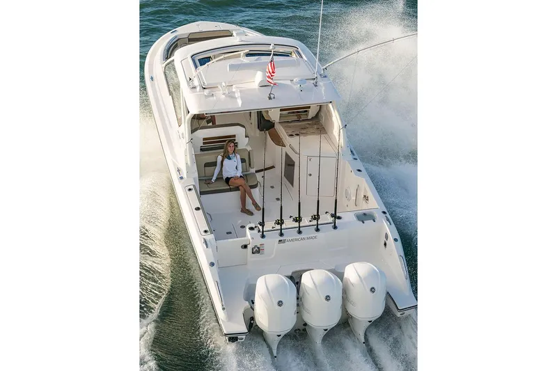 Slide: The Image of Manufacturer Provided Image: 2019 Pursuit DC 365 Dual Console boat cruising with triple outboard engines. - 82