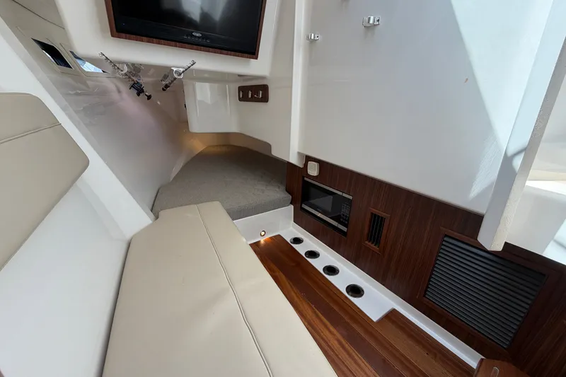 Slide: The Image of Interior of 2019 Pursuit DC 365 Dual Console boat with seating and wood accents. - 52