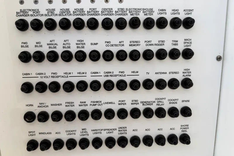Slide: The Image of Control panel of a 2019 Pursuit DC 365 Dual Console boat with labeled switches. - 23