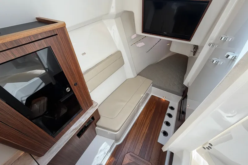 Slide: The Image of 2019 Pursuit DC 365 Dual Console interior with wood accents and seating area. - 48