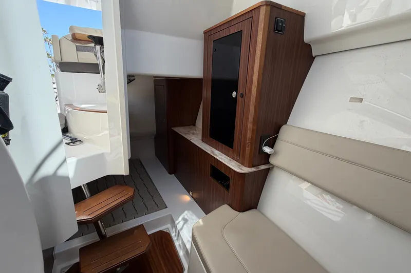 Slide: The Image of 2019 Pursuit DC 365 Dual Console interior with seating, cabinetry, and modern amenities. - 57