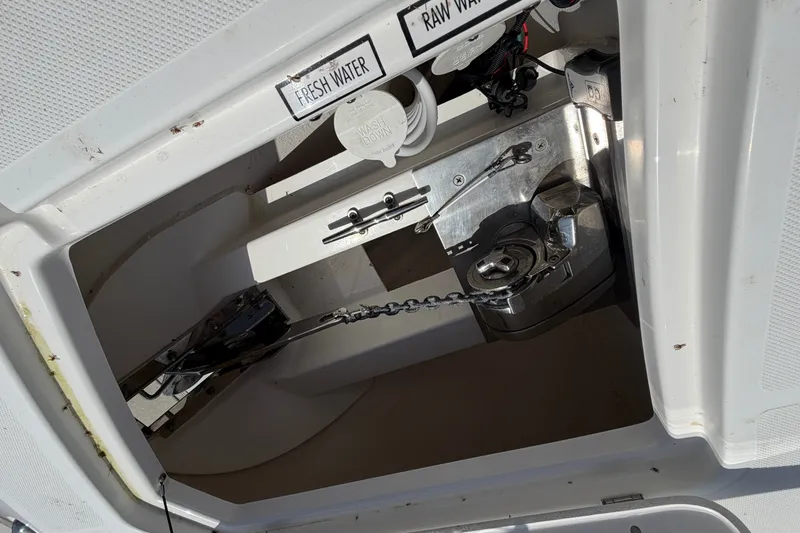 Slide: The Image of Anchor compartment of 2019 Pursuit DC 365 Dual Console boat with fresh and raw water access. - 78