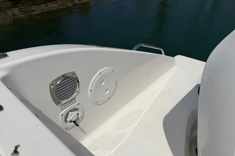 Slide: The Image of 2019 Pursuit DC 365 Dual Console boat with fresh water access panel. - 76