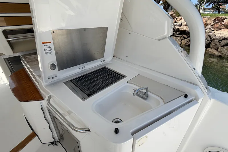 Slide: The Image of 2019 Pursuit DC 365 Dual Console boat with onboard sink and grill station. - 21
