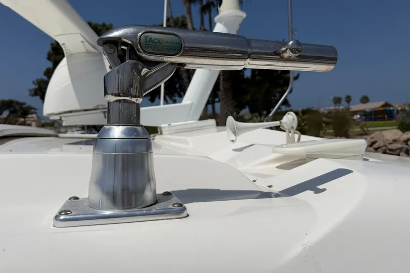 Slide: The Image of Close-up of a 2019 Pursuit DC 365 Dual Console boat's stainless steel rod holder. - 74