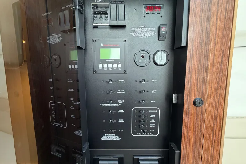 Slide: The Image of Electrical control panel on a 2019 Pursuit DC 365 Dual Console boat. - 49