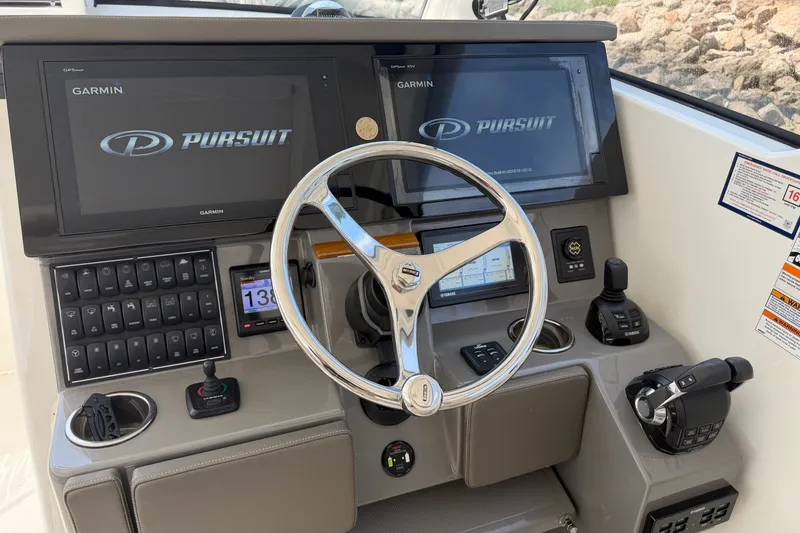 Slide: The Image of 2019 Pursuit DC 365 Dual Console helm with Garmin displays and modern controls. - 28
