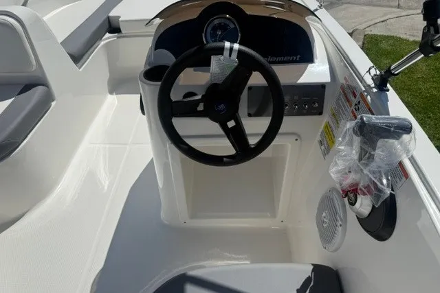 Slide: The Image of 2027 Bayliner Element E16 boat interior with steering wheel and dashboard controls. - 14