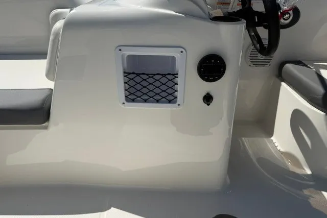 Slide: The Image of 2027 Bayliner Element E16 boat interior with steering wheel and storage compartment. - 18