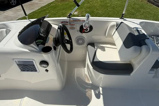 Slide: The Image of 2027 Bayliner Element E16 boat interior with steering wheel and seating, showcasing modern design. - 17