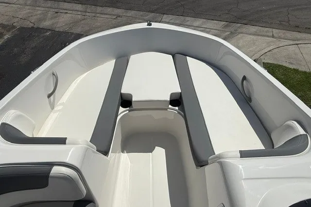 Slide: The Image of 2027 Bayliner Element E16 boat interior with white and gray seating. - 19